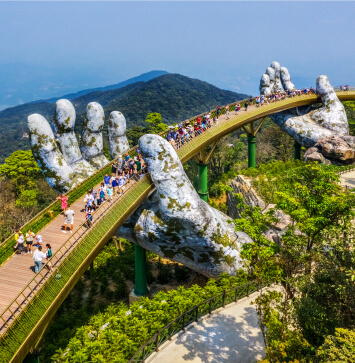 Golden Bridge held by giant stone hands, showcasing the unique and awe-inspiring attractions explored in our Vietnam tours