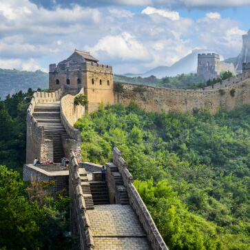 Great Wall of China surrounded by lush greenery, symbolizing the rich history and cultural experiences offered in our customized China tour